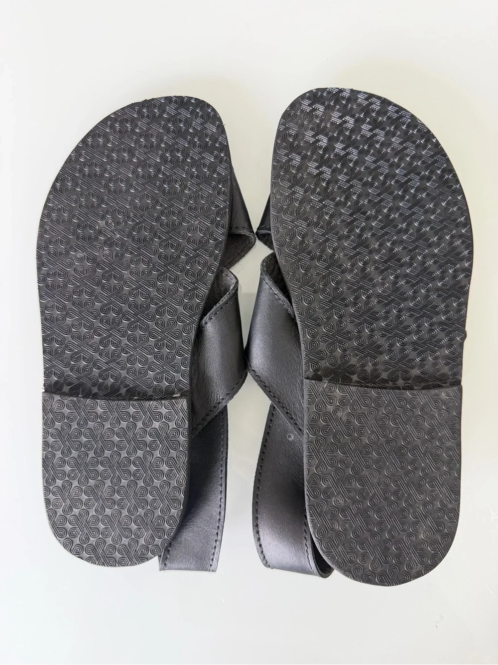Black Leather Cross-Strap Sandals with Gold Medallion Accent